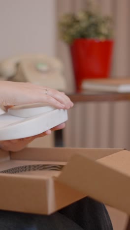 hands unboxing a product from a cardboard box