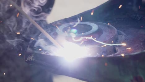 Electrode-Welding-a-Piece-of-Steel-Making-Sparks-and-Smoke---Close-Shot-Slowmotion