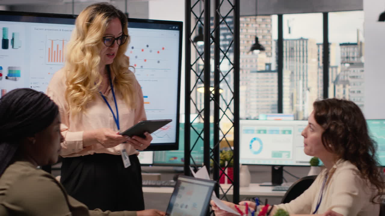 Vertical Video Ambitious CEO presenting performance indicators to her staff in a boardroom