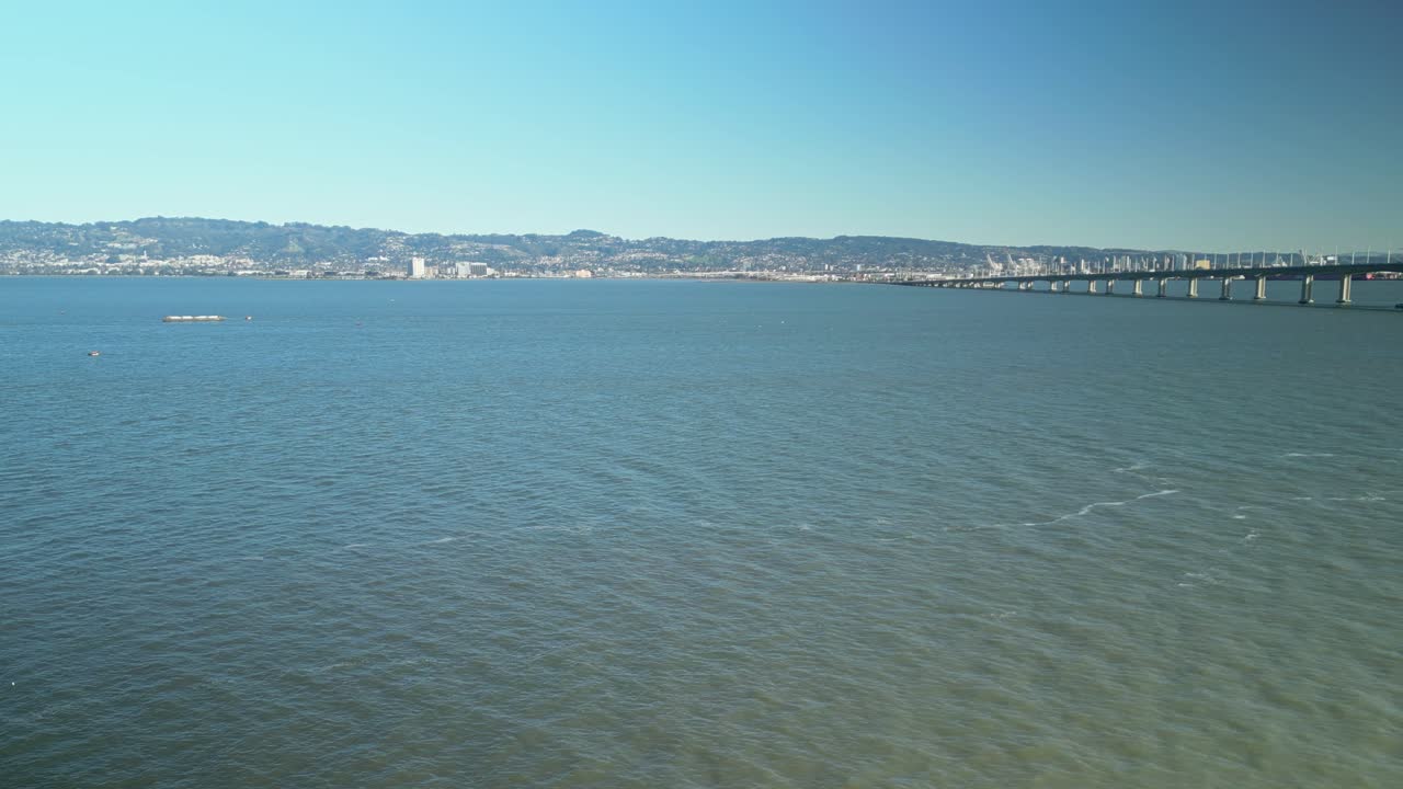 Pan drone shot of San Francisco-Oakland Bay Bridge with Pacific Ocean in California, USA