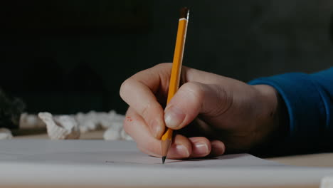 person drawing with pencil