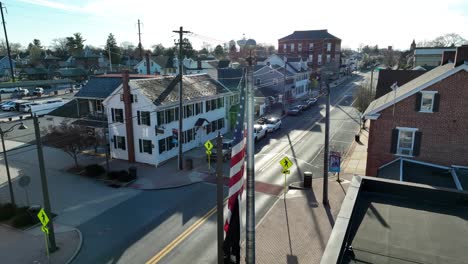 us flag waving in the summer street of small town in america