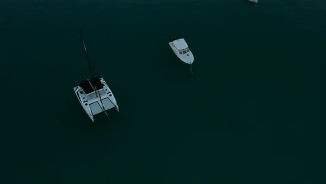 Aerial-shot-rotating-over-a-catamaran-and-two-others-small-boats