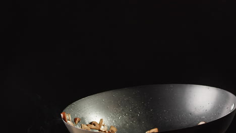 mushrooms stir-frying in wok