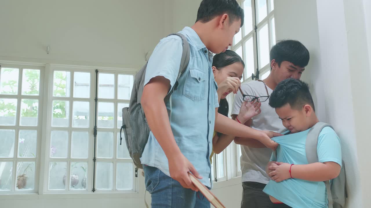 Young Asian Students Slapping Little Boy Demonstrating Disrespect, Cruelty. Bullying, Discrimination And Racism Concept