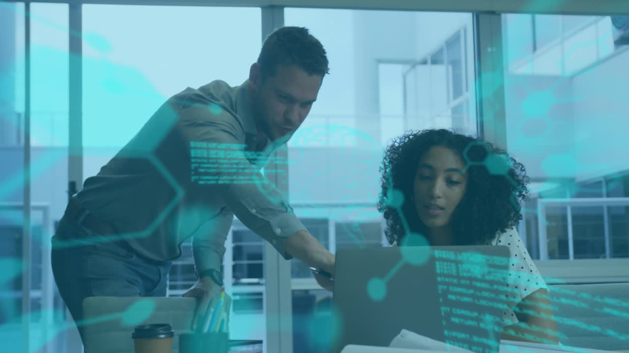 Man and woman collaborating at office desk with digital data overlay animation