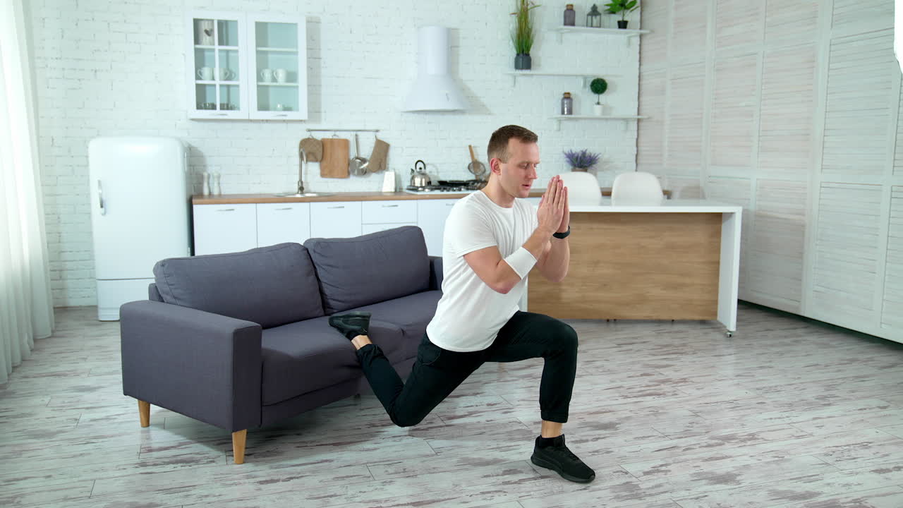 Sportsman doing morning fitness routine. Young man doing sports exercise at home