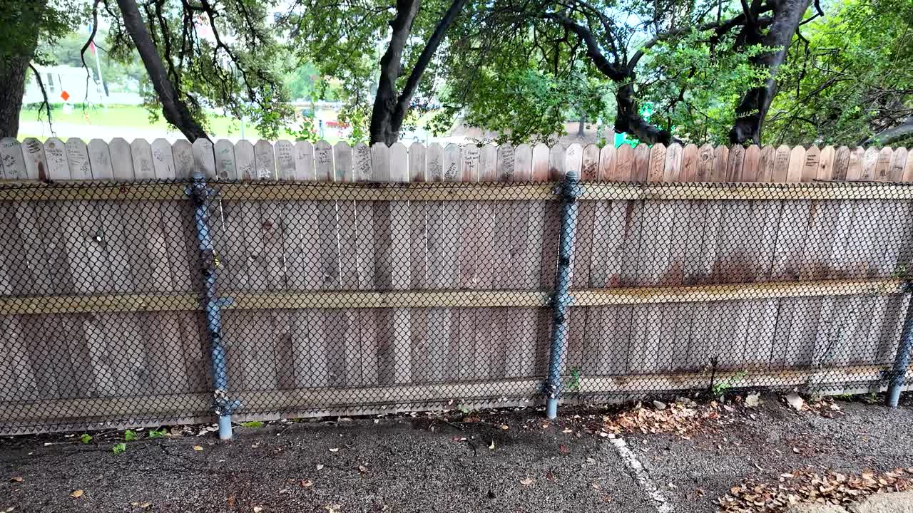 View of backside of grassy knoll fence