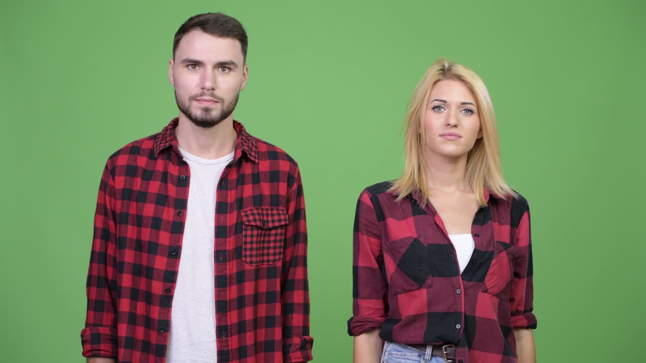 Young happy couple giving handshake together