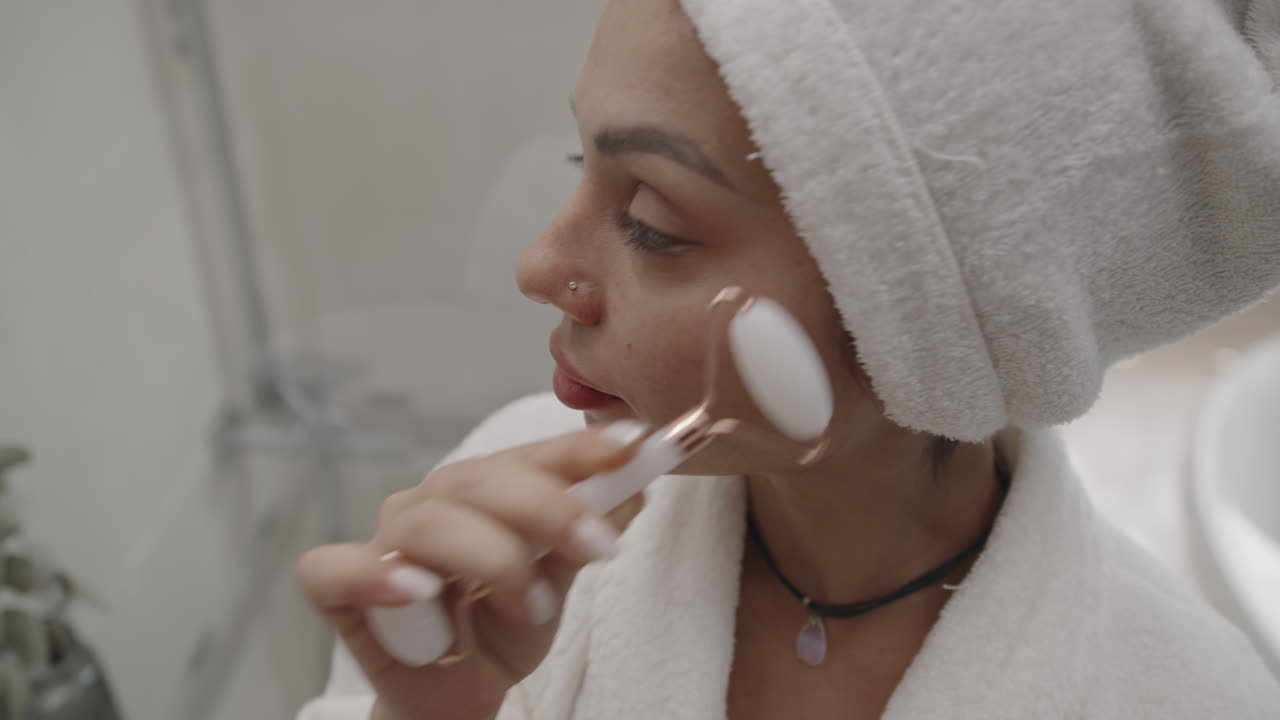 Caucasian Girl Massaging Cheeks with Facial Roller