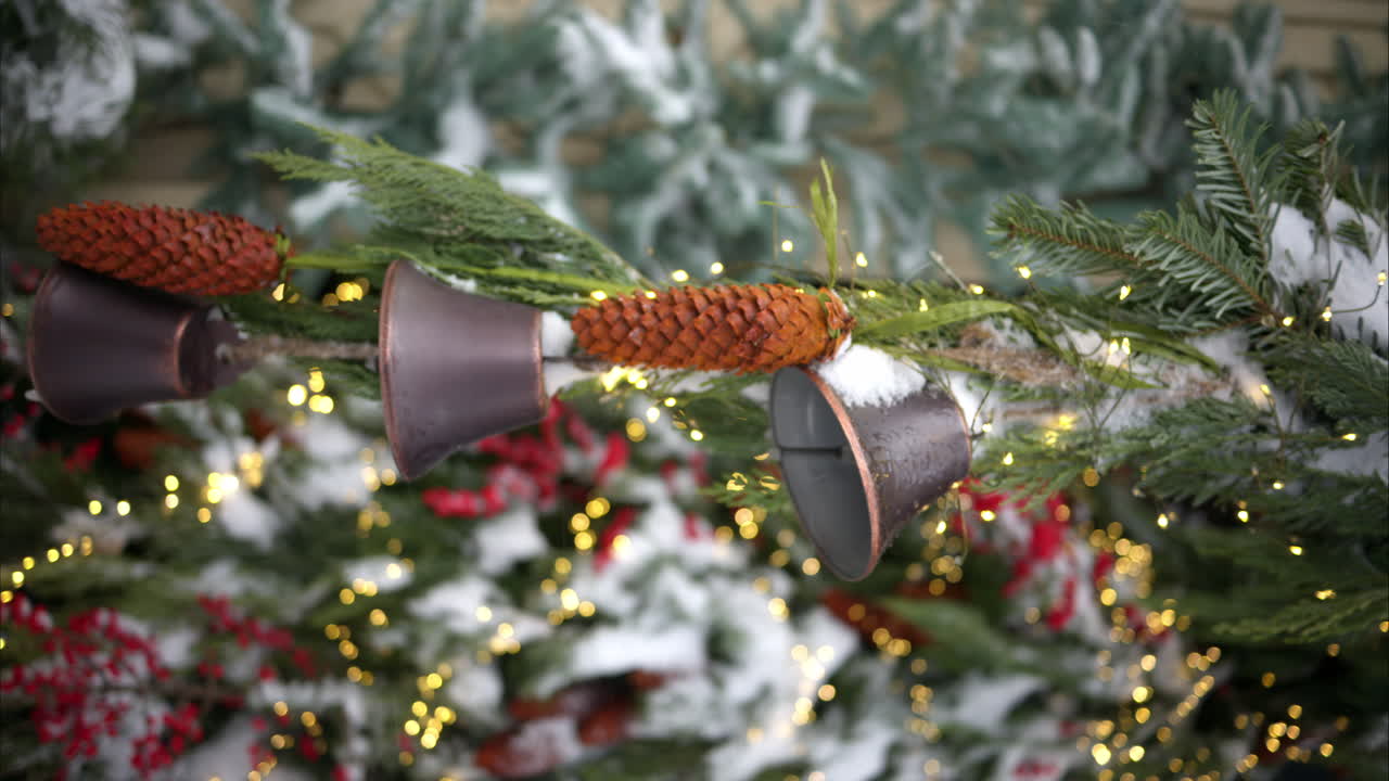 Christmas fir tree with decoratons bells outside and white snow