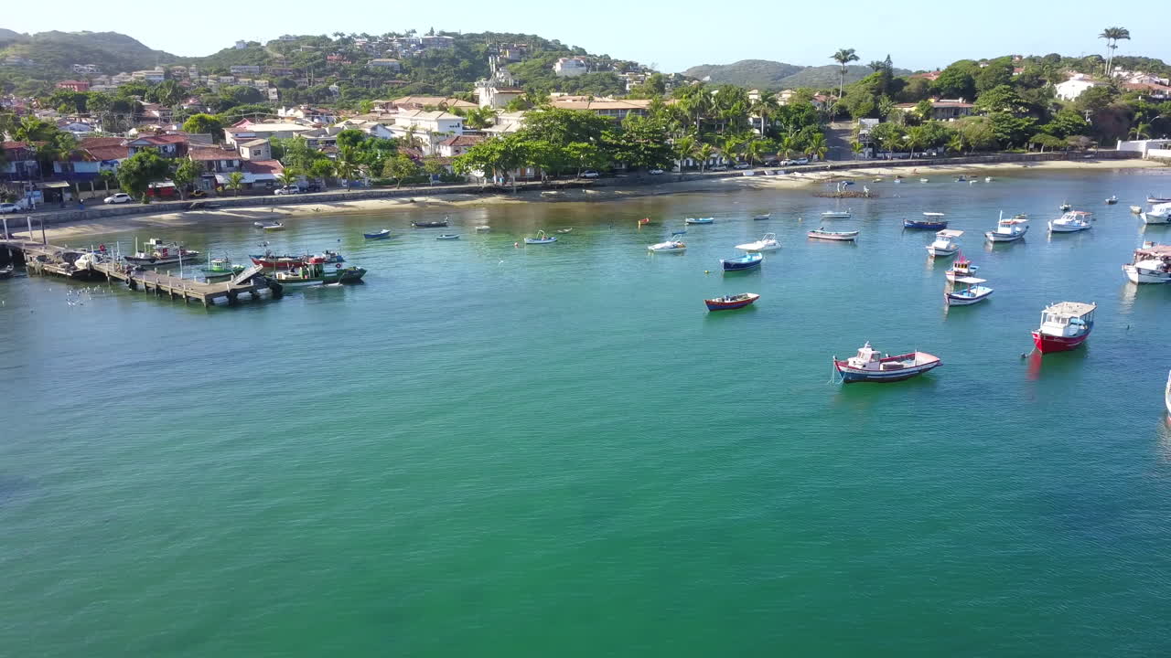 Drone flight over beach with boats in Buzios, Brazil