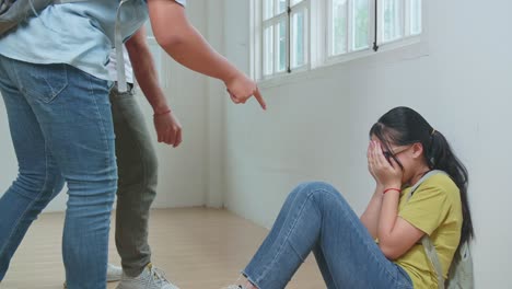 young asian students bullying caucasian girl in glasses