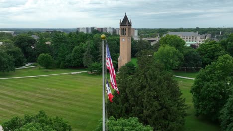 american flag and stanton memorial carillon tower at iowa state university campus in summer