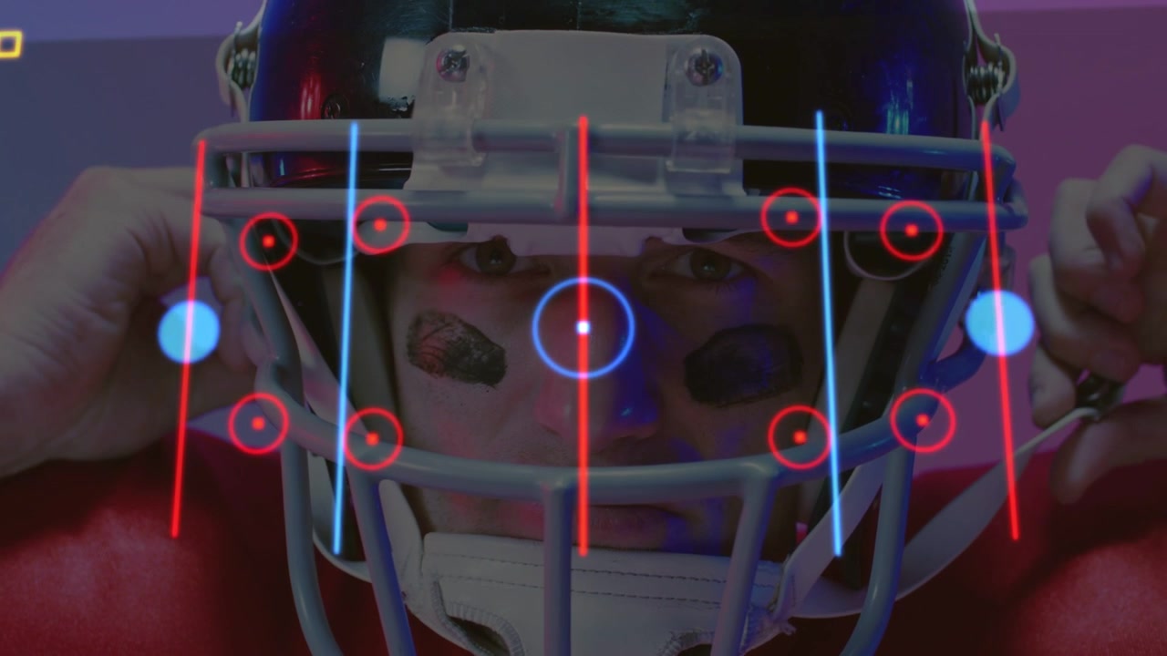 Football player fastening chinstrap, activating HUD overlay on helmet and revealing tactical play