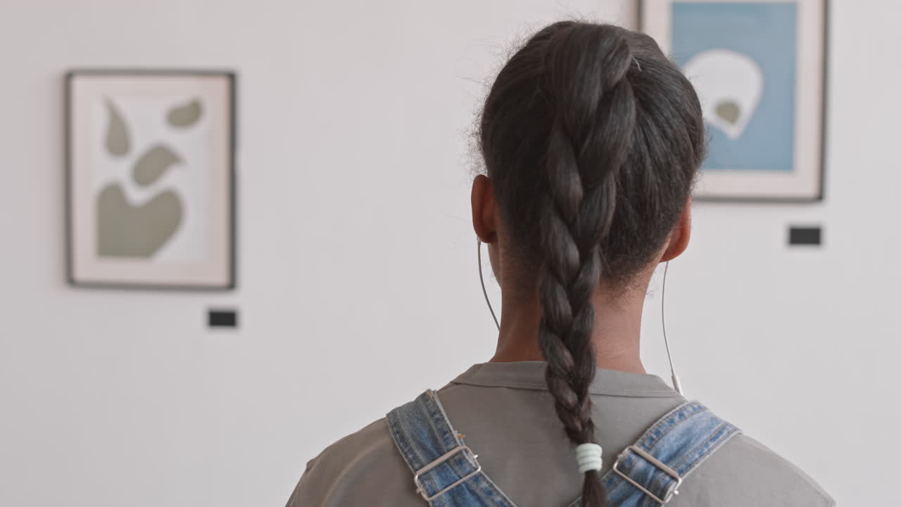 Girl Using Audio Guide in Gallery