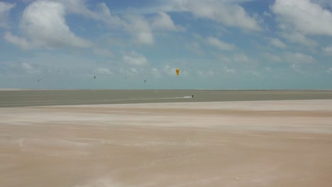 Aerial:-The-lagoon-of-Atins,-Brazil-with-people-kitesurfing