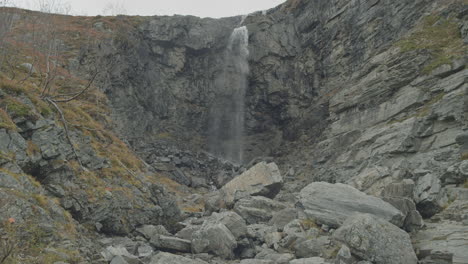 waterfall between rocks in rugged environment