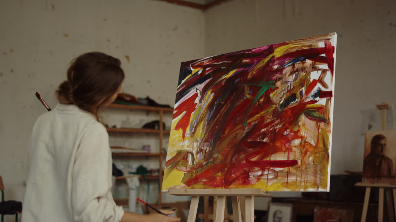 vista posterior de una artista femenina pintando en el interior. un pintor creativo dibujando en el estudio.