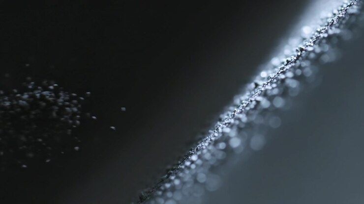 Shaking diagonal ridge coated with grains shedding from vibration in studio directional light