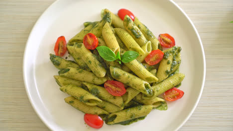 penne pasta with pesto sauce and tomatoes - vegan and vegetarian food style