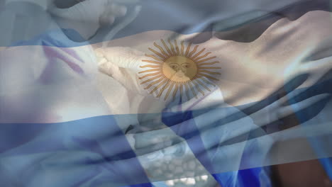 animación de la bandera de argentina sobre diversos cirujanos con máscaras faciales.