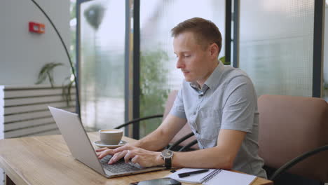 happy business man working on laptop from home office. male executive using computer remote studying browsing web having virtual meeting typing on computer. remote office