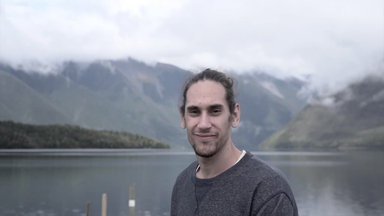 Person overlooking lake and mountains