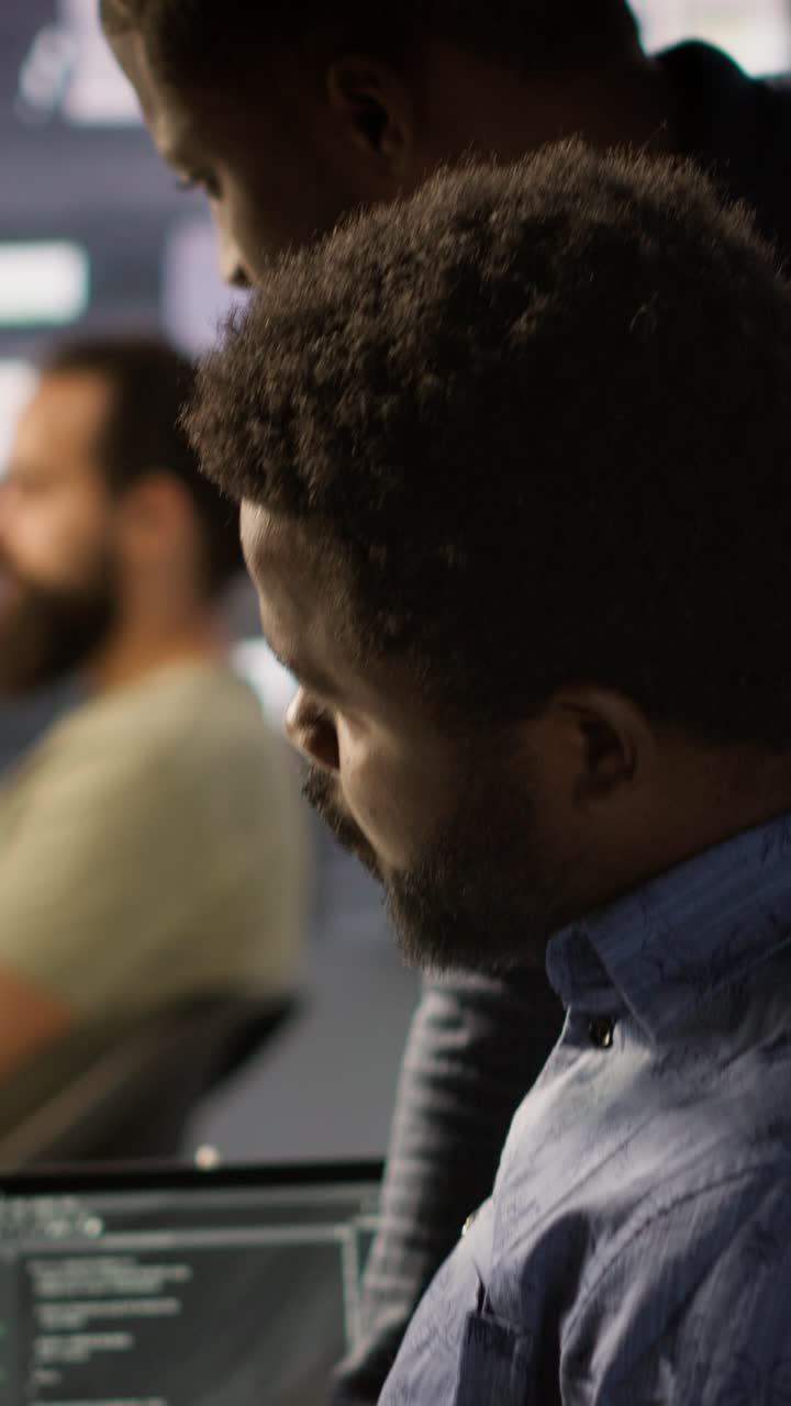 Vertical video Programmer waiting for coworker to come help him fix applications issues