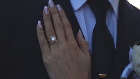 bride lays hand on grooms chest