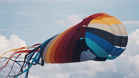 a close-up shot of a parafoil kite floating in the air at the romo kite festival