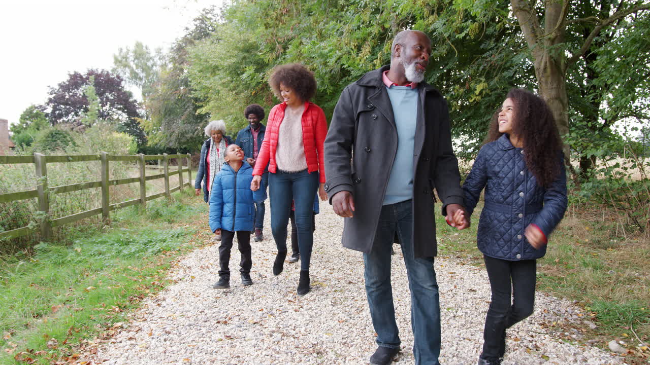 Multi Generation Family On Autumn Walk In Countryside Together
