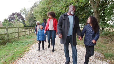 multi generation family on autumn walk in countryside together