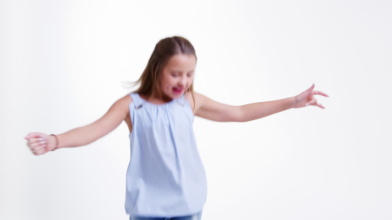 Girl Jumping Against White Studio Background