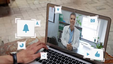 digital internet icons over man using laptop during video call.