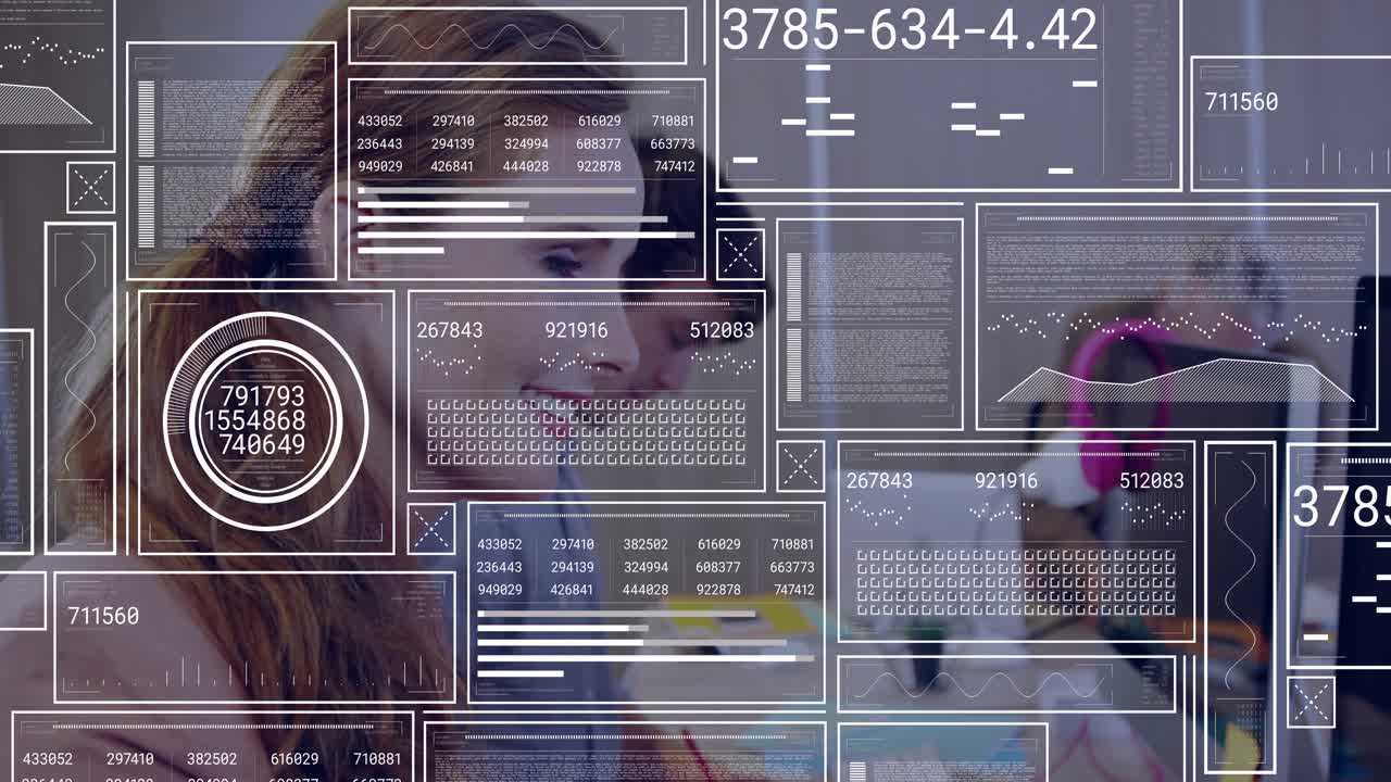 Data overlays scrolling leading businesswoman leaning in, typing keys, smiling toward coworker