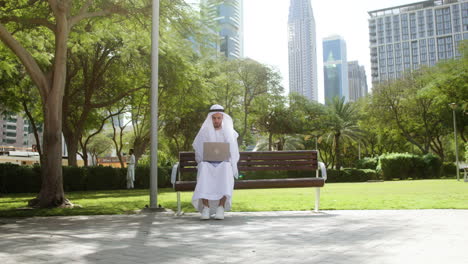 man sitting on the bench of a park