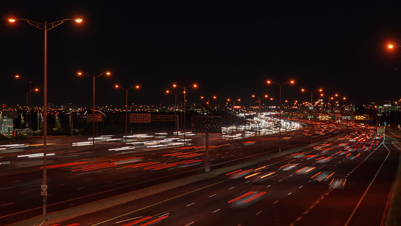 Hwy 401 Ontario night timelapse with fast car lights and city view