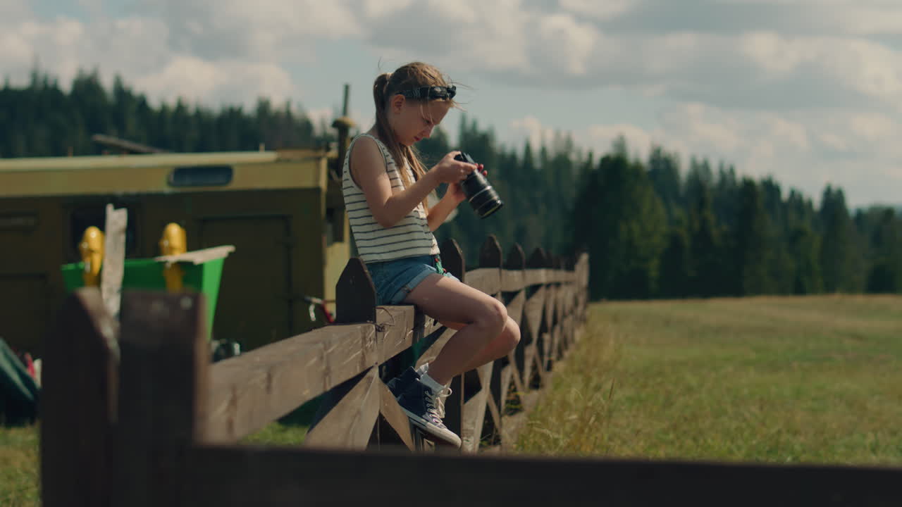 Young Girl Photographer Changing Camera Settings Young Photographer Changing Camera Settings Girl Concentrating on Process Shooting Beautiful Nature Landscape Spending Leisure Time Outdoor Shot Phone Screen View Slow Motion