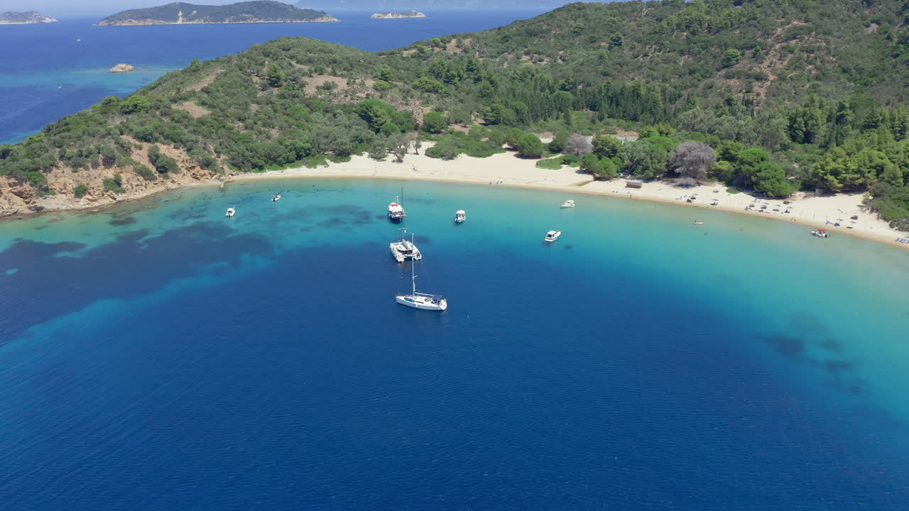 Aerial: Sailboats and catamarans on Tsougria island beach near Skiathos, Sporades, Greece
