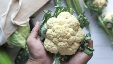 cauliflower held in hands