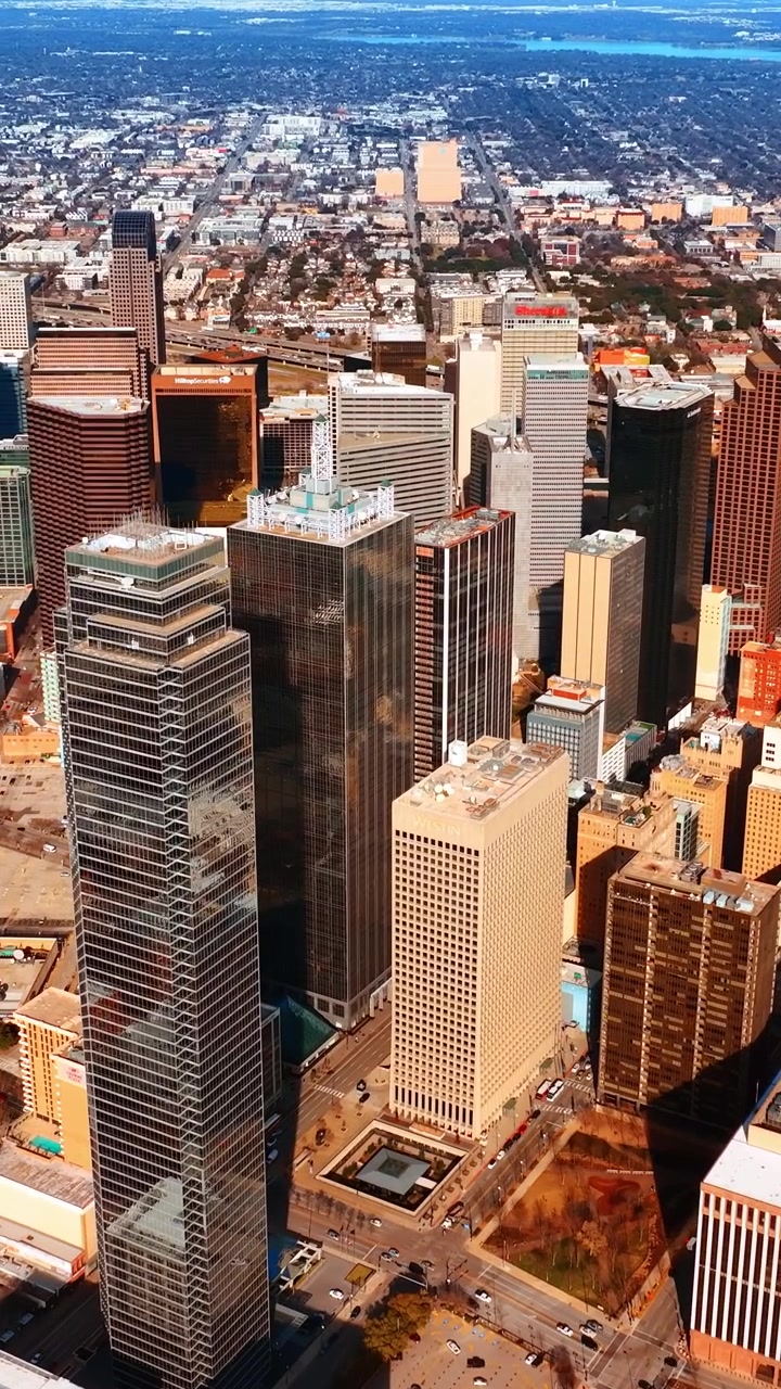 Scenic view of Dallas downtown on sunny day. Slowly approaching the high-rise architecture in the metropolis midtown. Vertical video