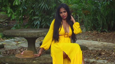 una dama con un vestido amarillo fluido posando en los vibrantes terrenos verdes de un antiguo castillo.