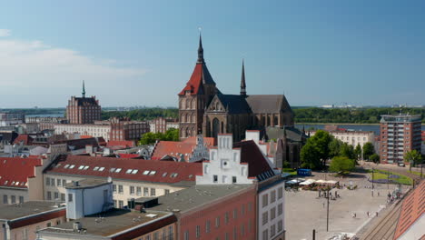 Aerial-view-of-town-square-with-historic-colourful-gabled-houses-and-Saint-Marys-church.-Wide-river-estuary-in-distance