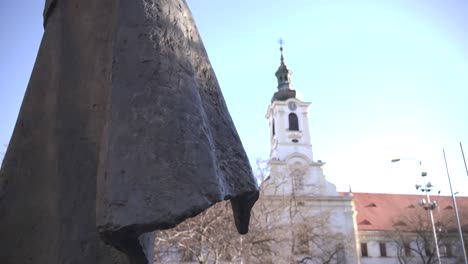 statue of priest and church at slovakian uprising memorial, bratislava
