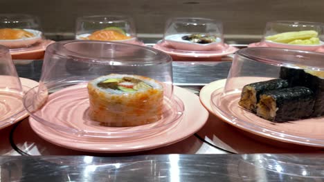 4k, sushi moving conveyor belt in japan restaurant. traditional kaitenzushi