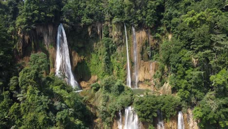 an aerial rotational 4k drone shot of the jungle of umphang and the outstanding thi lo su waterfall, located deep in the country of backpackers paradise of thailand in southeast asia