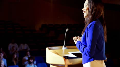 Young-mixed-race-businesswoman-speaking-in-business-seminar-at-auditorium-4k