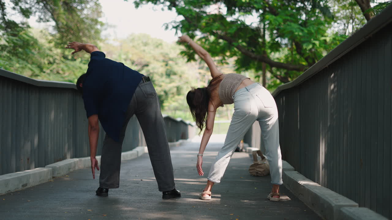 Couple Stretching Together in a Park
