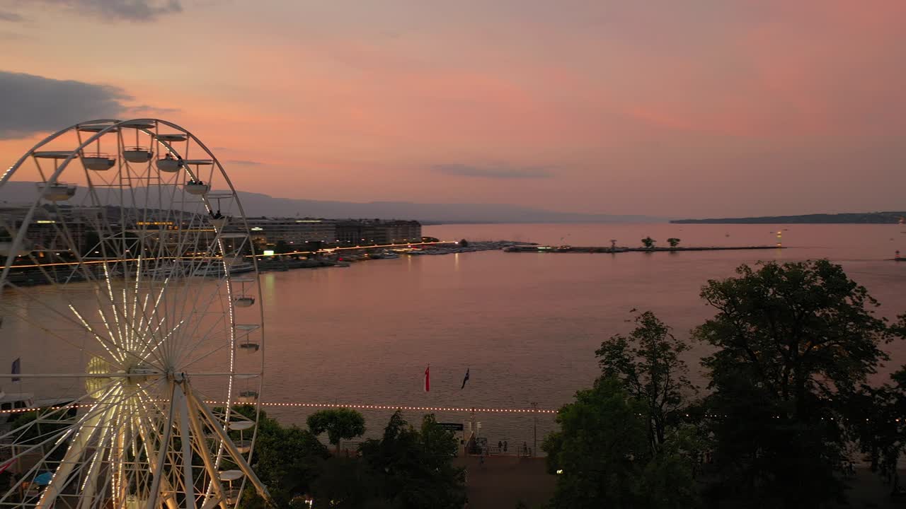 sunset sky night illumination geneva city center lakeside fountain ferris wheel aerial panorama 4k switzerland